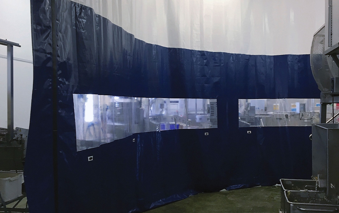 White and blue Flexicurtain with vision panels for washdown during production